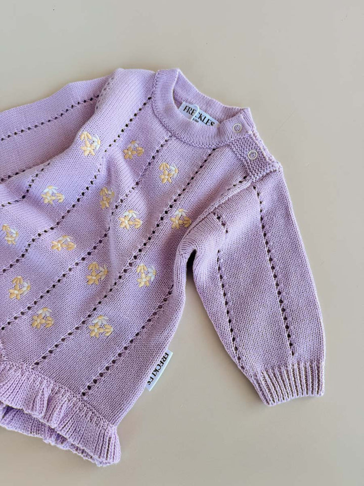 Close view of the Aster pointelle knit and daisy embroidery