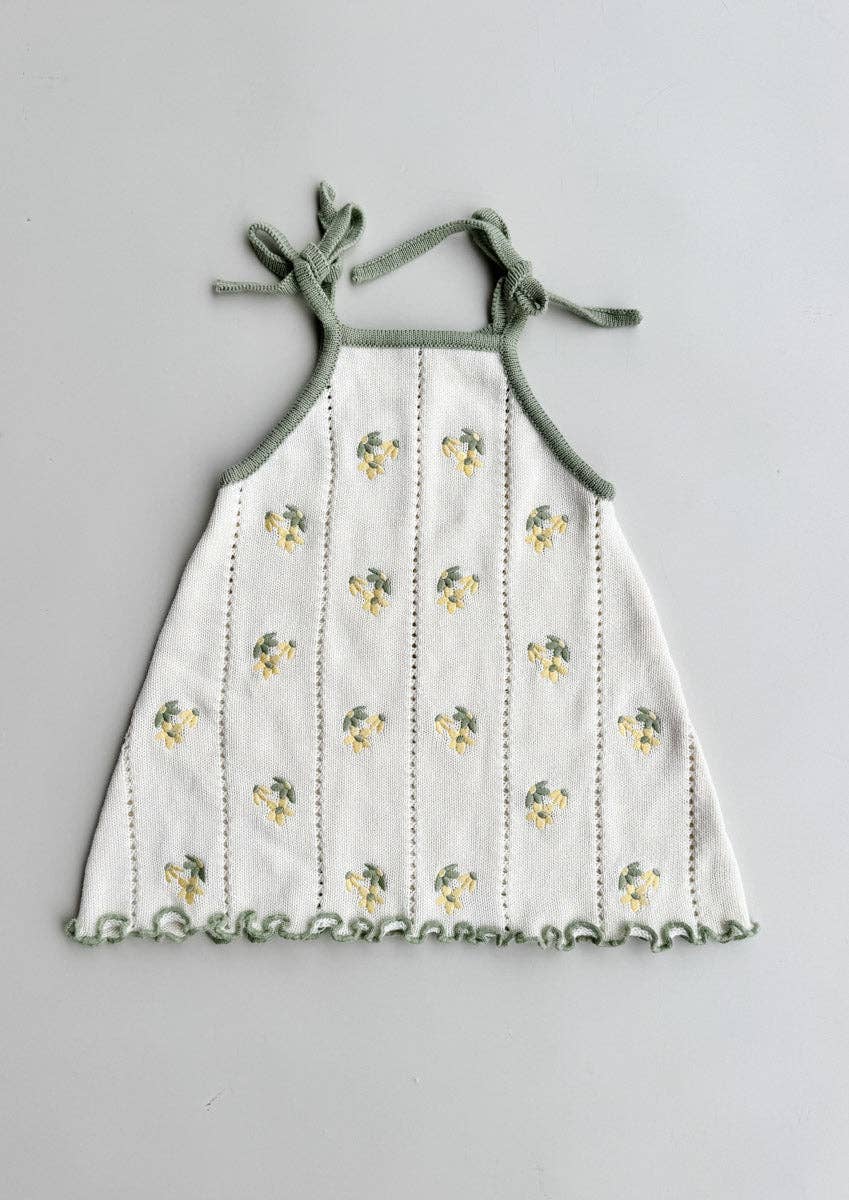 Freckles Bloom Pointelle Tie Dress in Snow/Sage laid flat, with sage tie straps and daisy embroidery