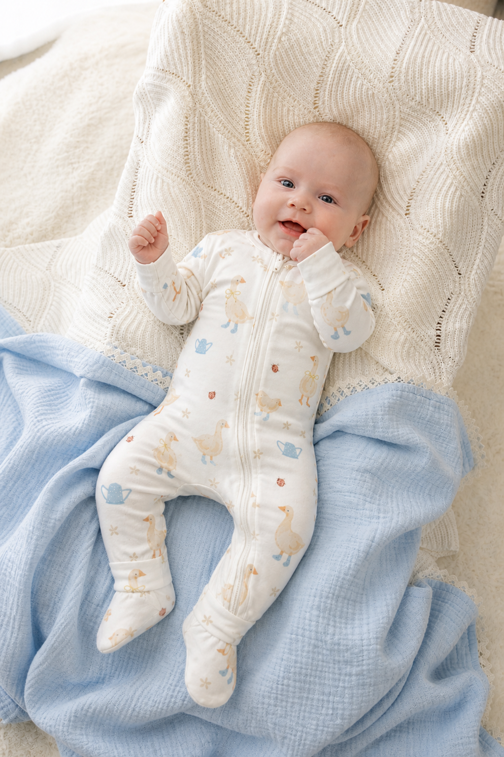 Baby wearing the Country Goose Zipsuit on a knit blanket