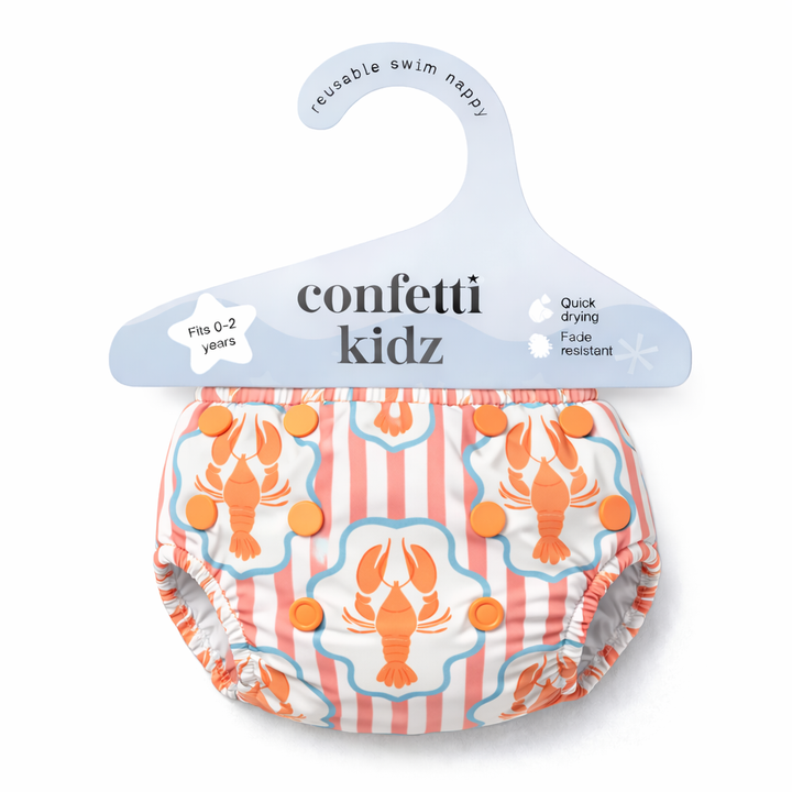 Confetti Kidz Reusable Swim Nappy in Coral Cray, in its packaging