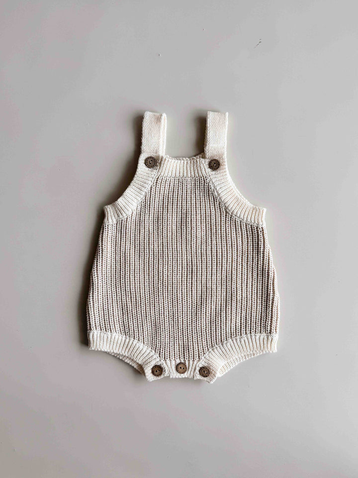 Freckles The Label Chunky Button Romper in Oat laid flat, with button suspender straps