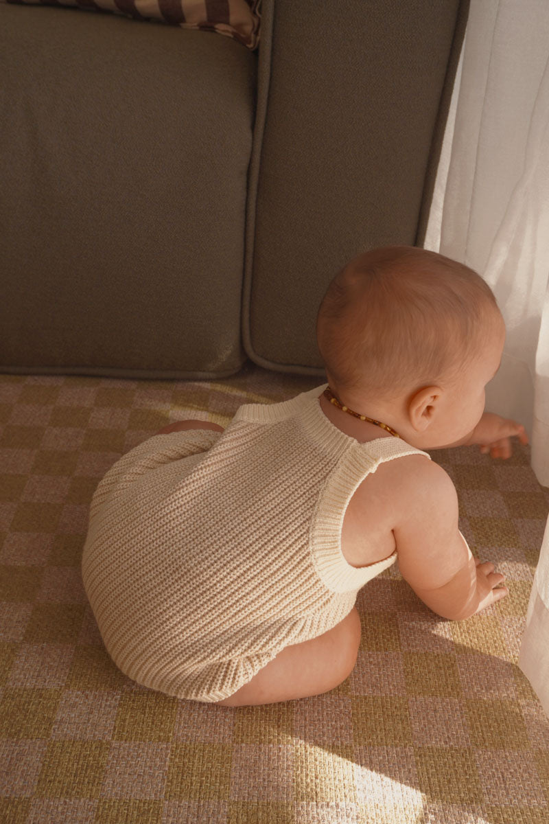Back view of the Freckles The Label Chunky Button Romper in Oat