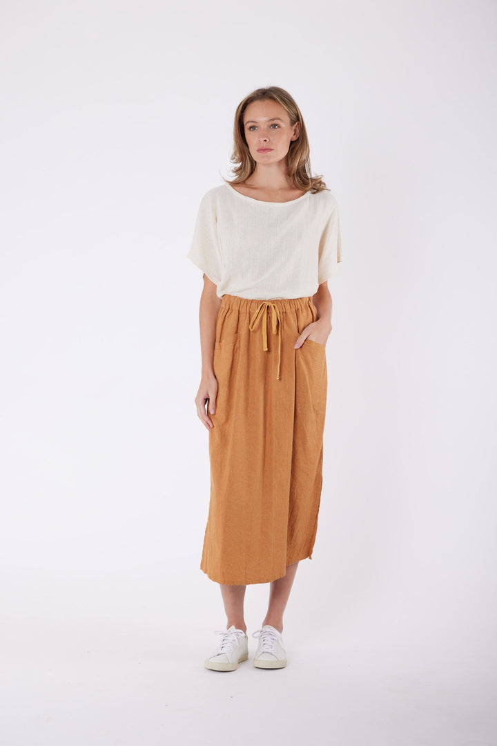 Isla Linen Midi Skirt in Tanzine, worn with a cream top, model shot 2