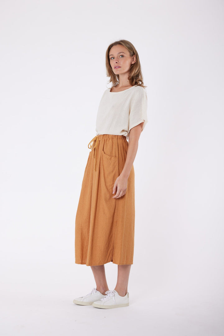 Isla Linen Midi Skirt in Tanzine, worn with a cream top, model shot 4