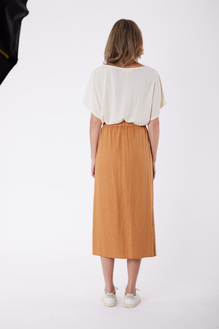 Isla Linen Midi Skirt in Tanzine, worn with a cream top, model shot 5