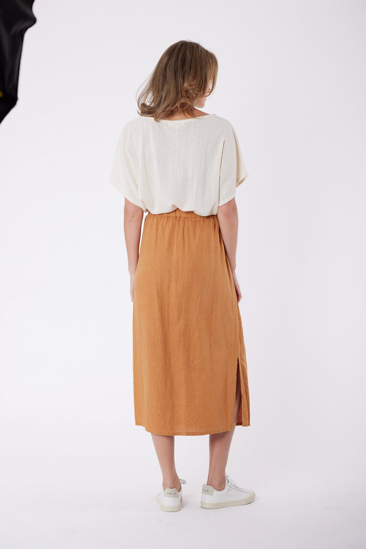 Isla Linen Midi Skirt in Tanzine, worn with a cream top, model shot 6