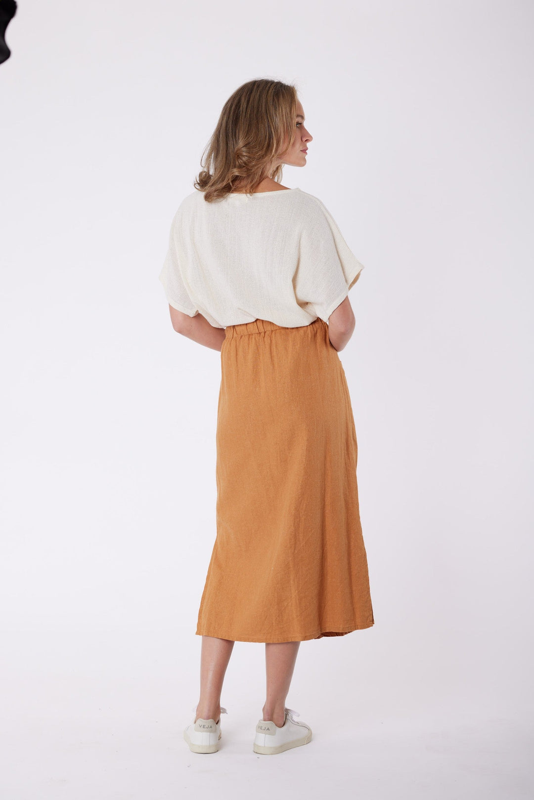 Isla Linen Midi Skirt in Tanzine, worn with a cream top, model shot 7