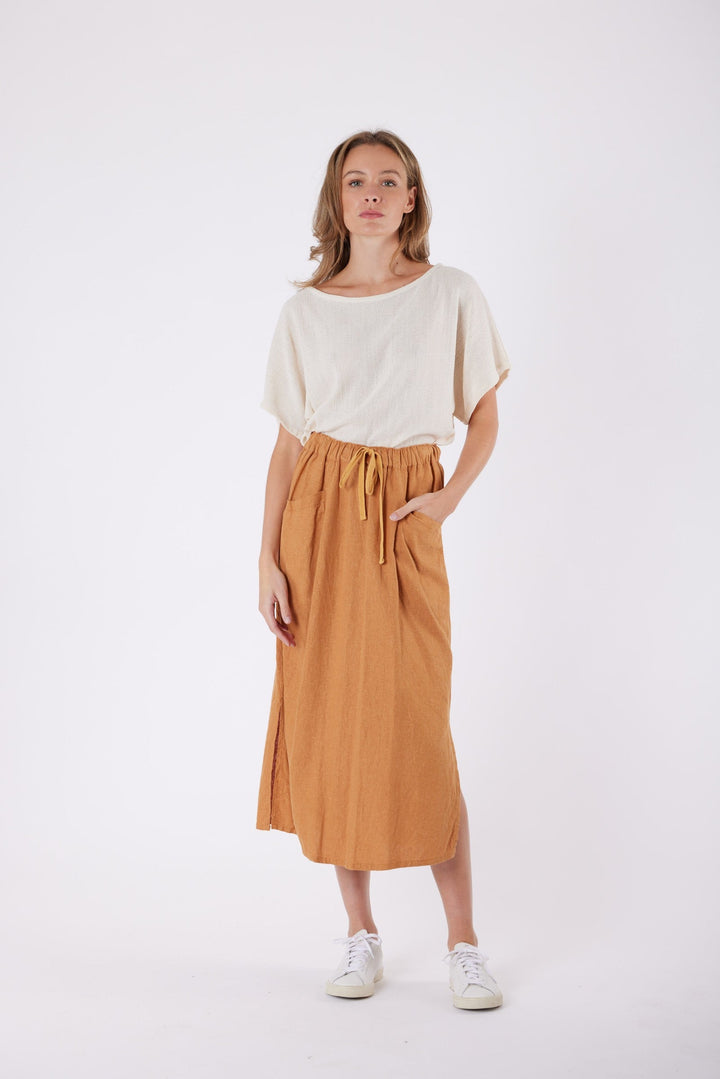 Isla Linen Midi Skirt in Tanzine, worn with a cream top, model shot 8