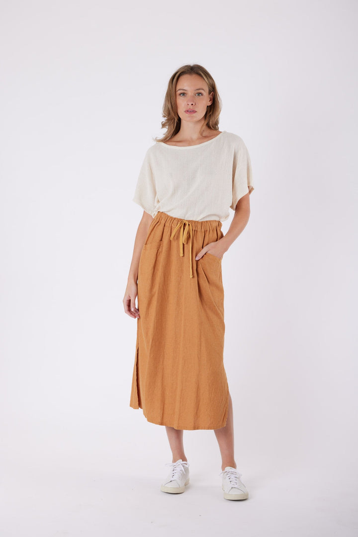 Isla Linen Midi Skirt in Tanzine, worn with a cream top, model shot 9