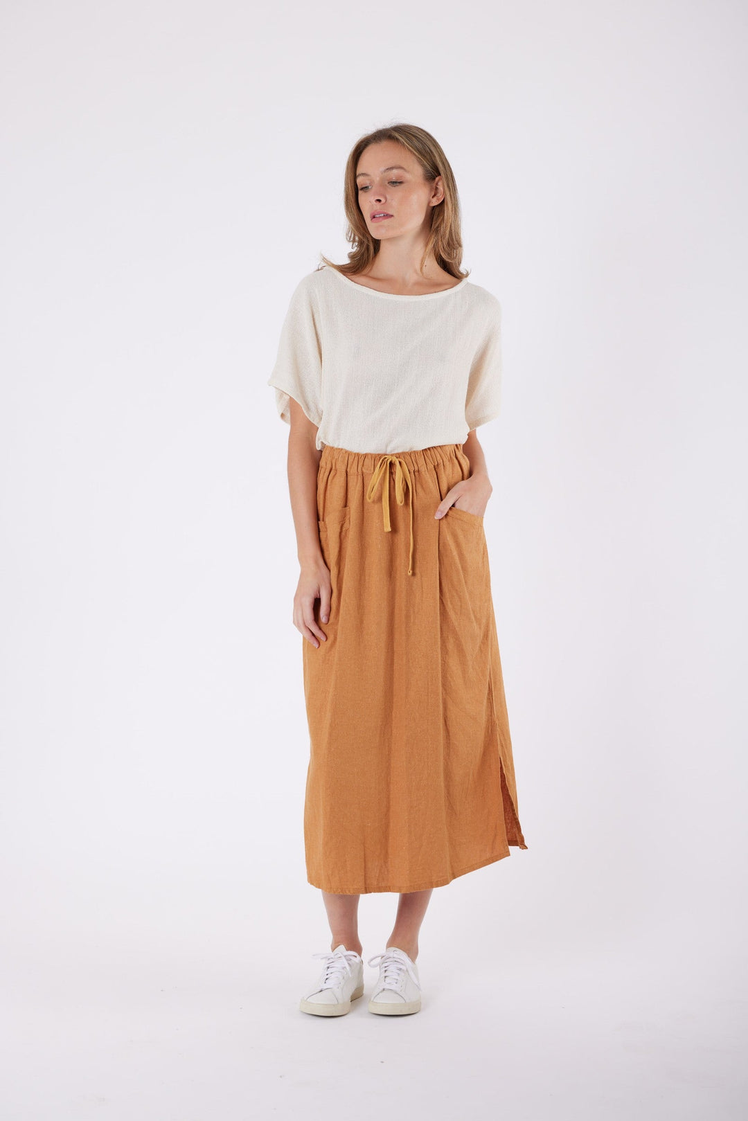 Isla Linen Midi Skirt in Tanzine, worn with a cream top, model shot 10