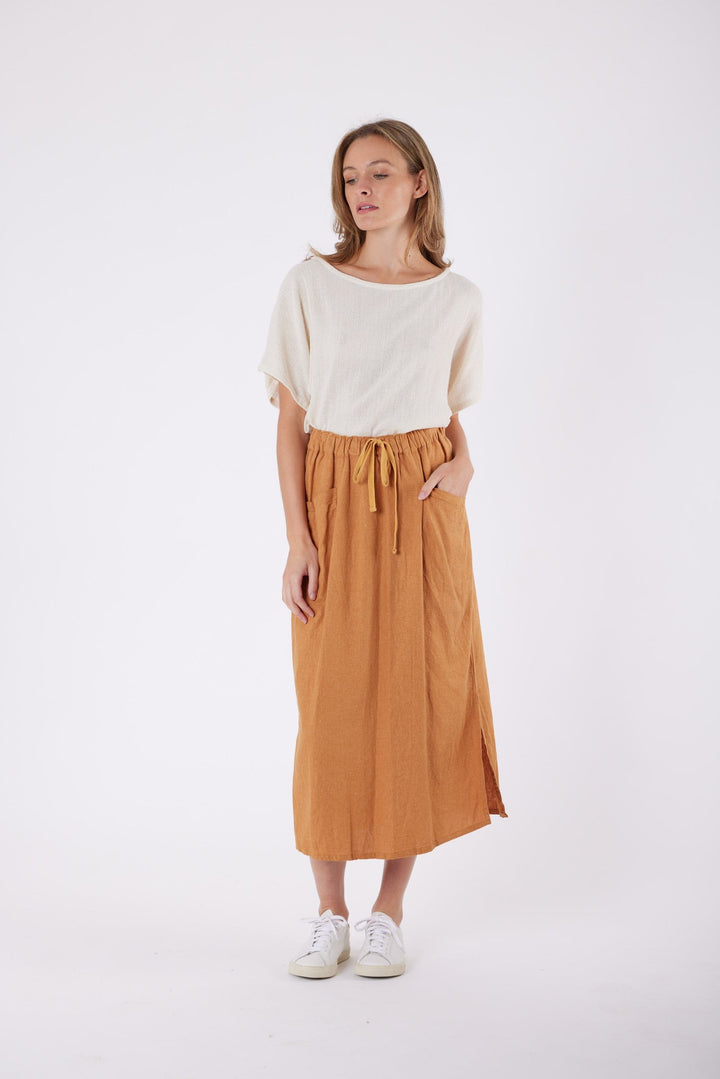 Isla Linen Midi Skirt in Tanzine, worn with a cream top, model shot 10