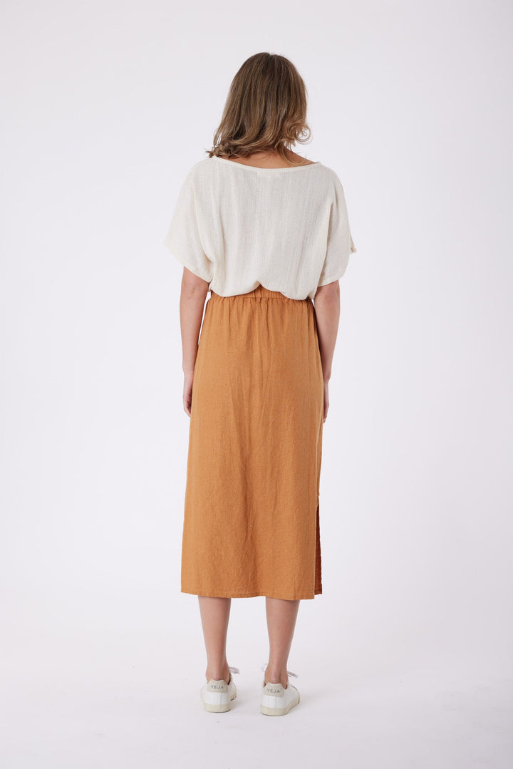 Isla Linen Midi Skirt in Tanzine, worn with a cream top, model shot 11