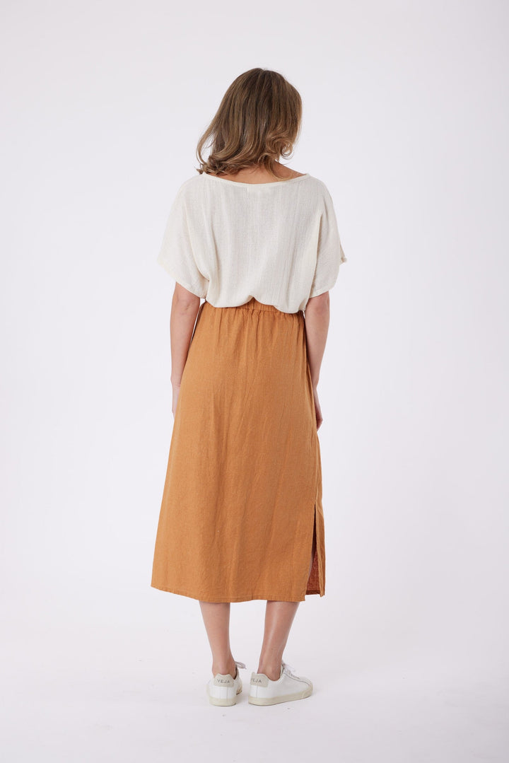 Isla Linen Midi Skirt in Tanzine, worn with a cream top, model shot 12