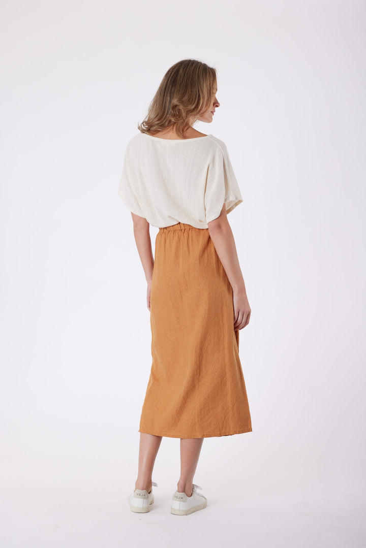 Isla Linen Midi Skirt in Tanzine, worn with a cream top, model shot 13
