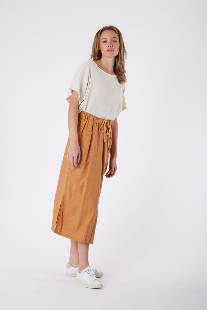 Isla Linen Midi Skirt in Tanzine, worn with a cream top, model shot 14