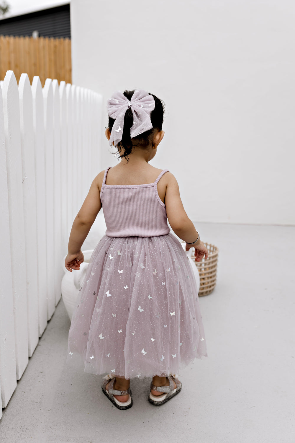 Girl wearing the Mauve Butterflies ribbed tulle dress, full length