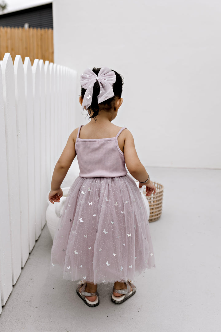Girl wearing the Mauve Butterflies ribbed tulle dress, full length