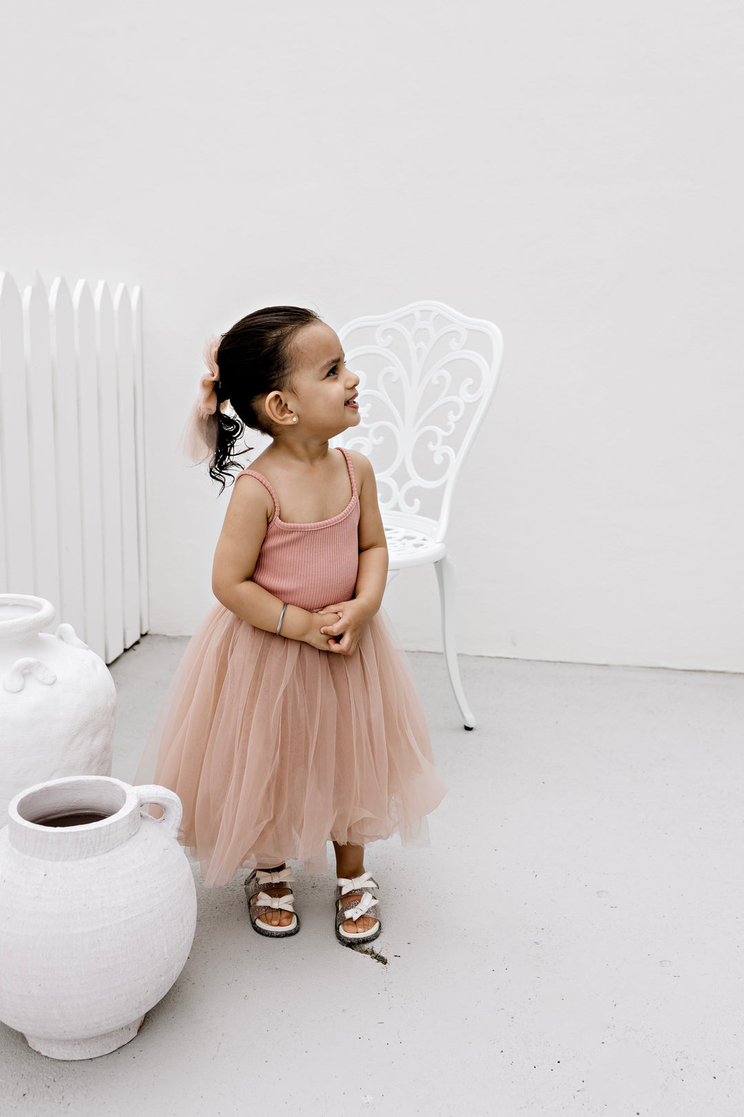 Girl wearing the Dusty Pink ribbed tulle dress, full length
